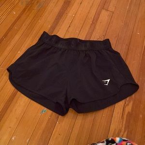 Black gymshark athletic shorts.